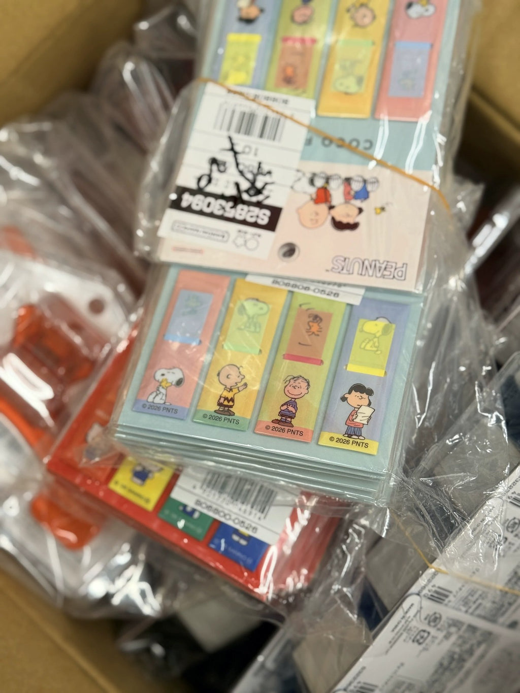 Hand holding the four COCO FUSEN Snoopy sticky note cases