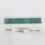 Snoopy handy scissors and cap laid horizontally with the PEANUTS print visible