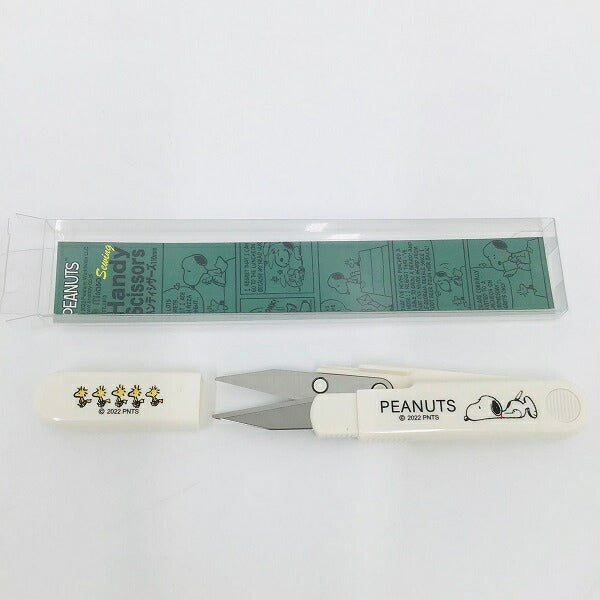 Snoopy handy scissors and cap laid horizontally with the PEANUTS print visible