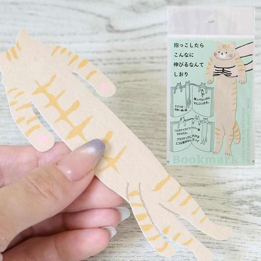 Hand holding the Chatora hugging cat bookmark with its packaging