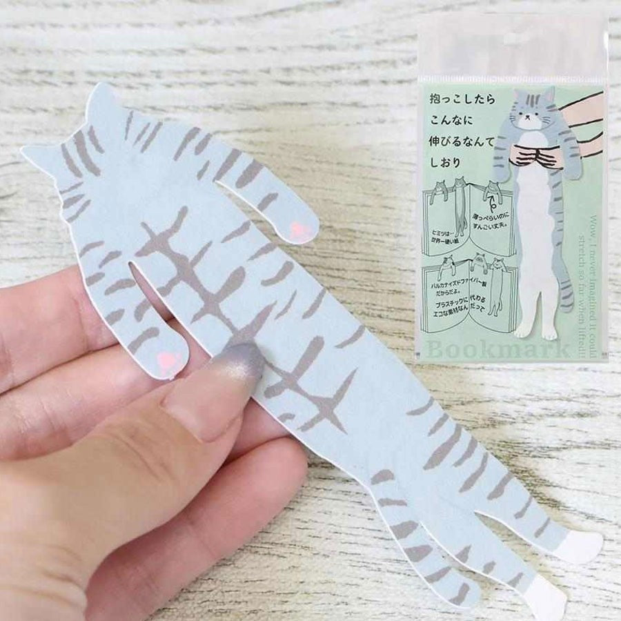 Hand holding the Sabashiro hugging cat bookmark with its packaging