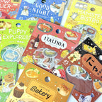 BGM foil flake sticker packs arranged together, showing animal café and cosy day designs