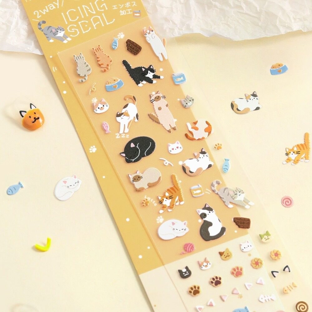 BGM icing seal sticker sheet with embossed cat motifs on a cream background