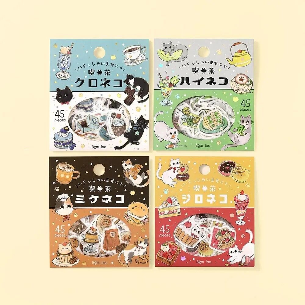 Four BGM Kissa Kuroneko foil flake sticker packs, each with a different cat in a café scene