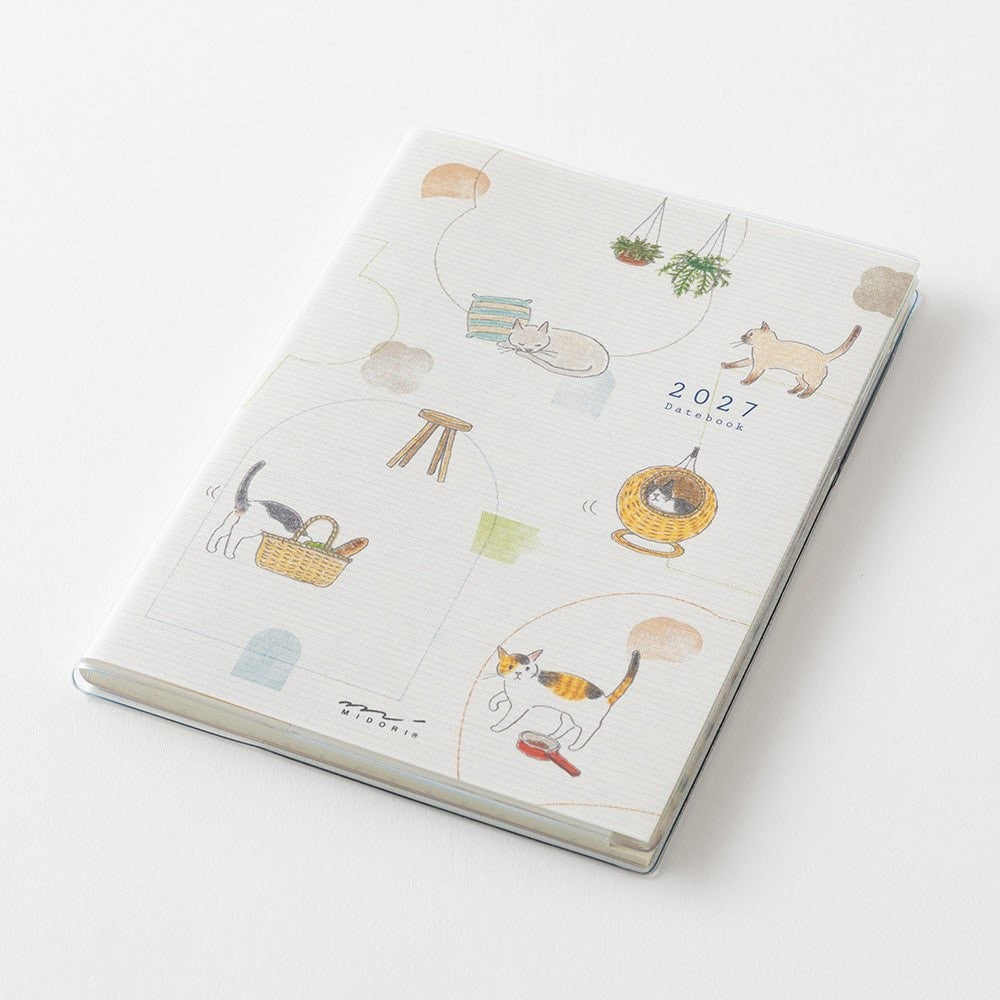 MIDORI Pocket Diary 2027 A6 cat planner open showing monthly pages and a cat drawing