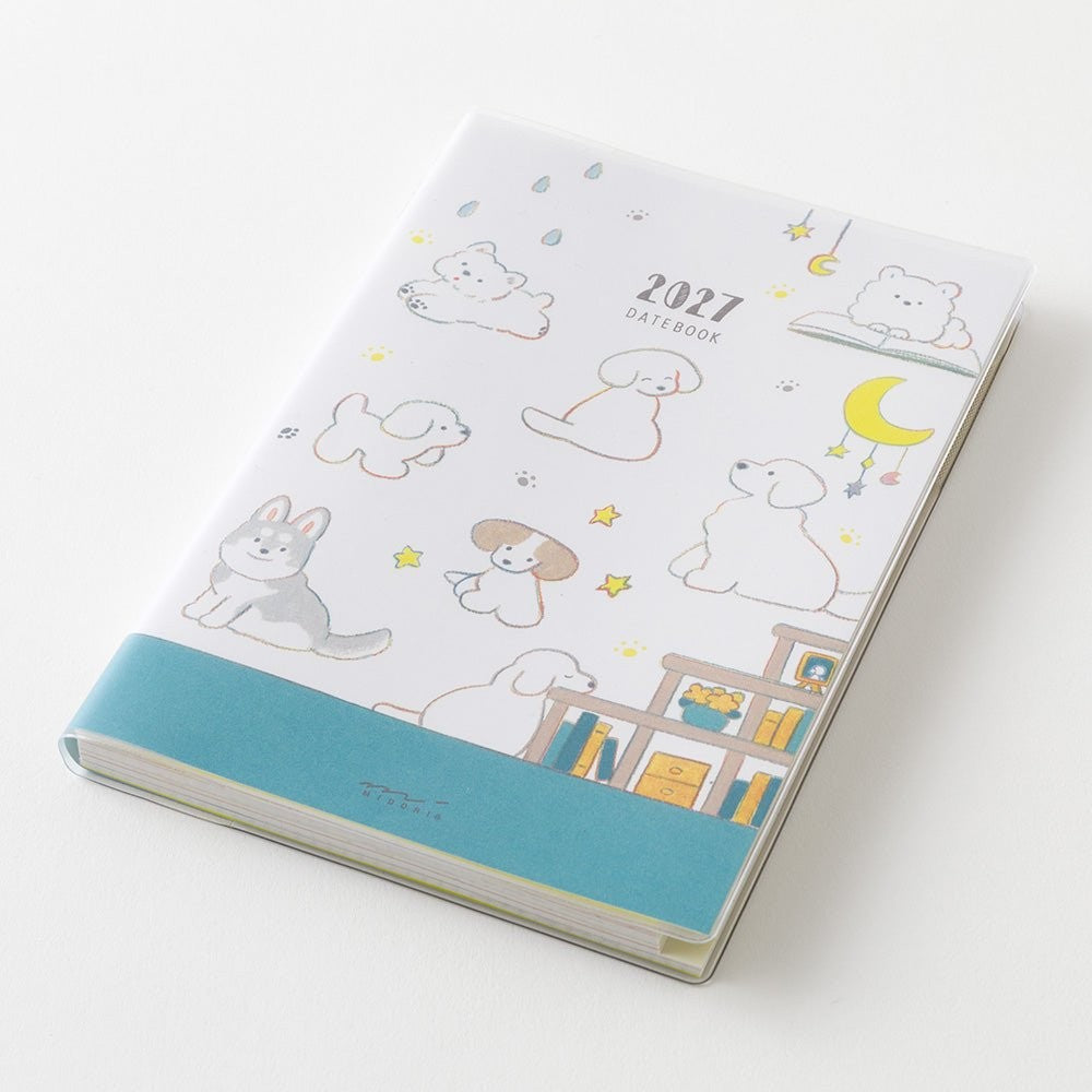 MIDORI Pocket Diary 2027 B6 dog planner open to the weekly pages beside the monthly block