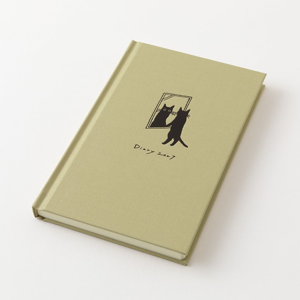 MIDORI Book Style Diary 2027 beige cat planner lying open next to its cloth cover